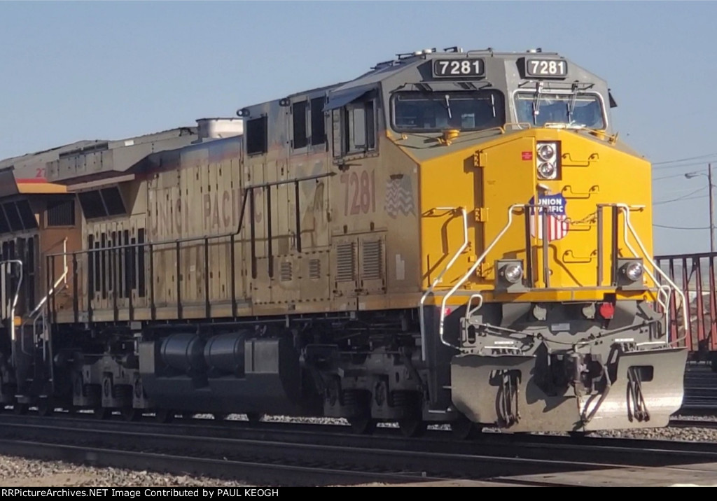UP 7281 A Very Brand New 2 Month Old C44ACM Remodeled Locomotive Leads A Train Consisting of Brand New Rails Heading to the UP Salt Lake City Yard Utah As The Wyoming Sun Reflects Off Her New UP Paint Scheme Paint.